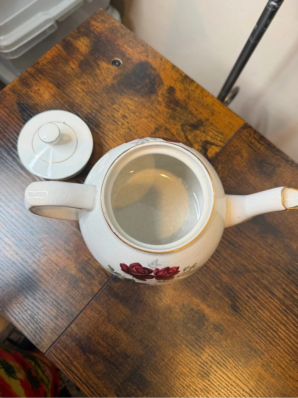 Vintage Ellgreave England red rose teapot featuring delicate gold trim.